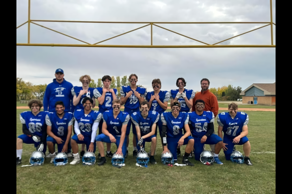 The KCI Spartans lined up for a team photo with their coaches Kody Rock, far left, and Mike Woollard, far right.