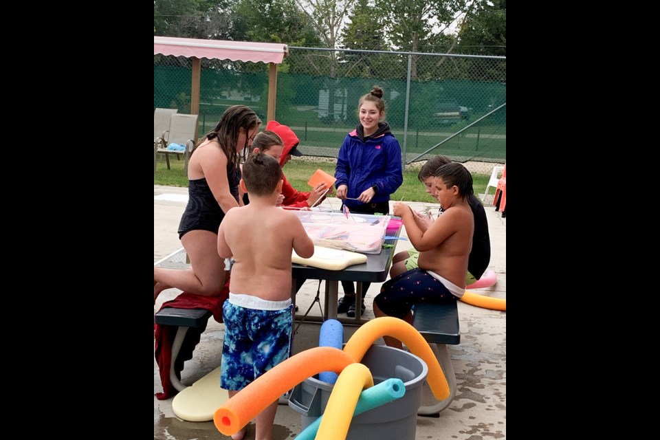 Lifeguard Makenna Marton supervises participants in the Swimming Pool’s ‘Build a Boat and Race’ event. 