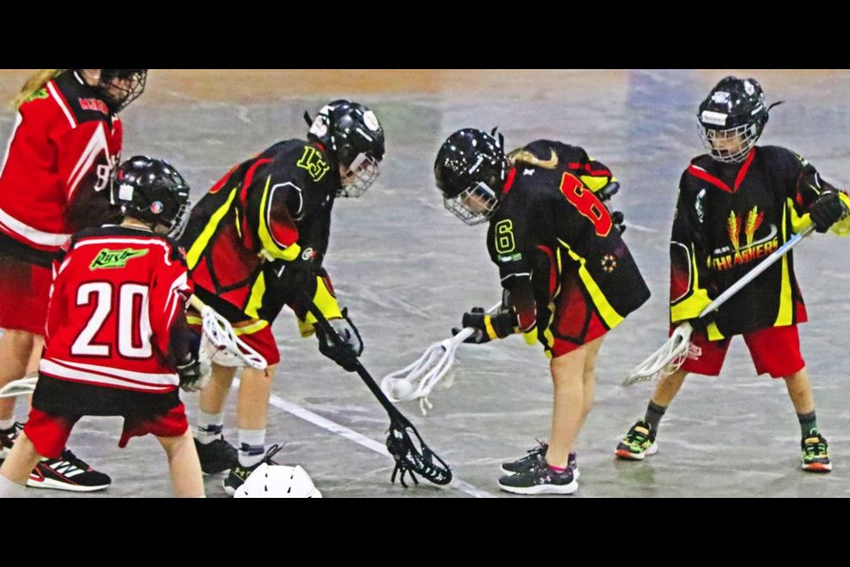 Thrashers players Jett Fox, left, and Mirabelle Leroux make sure the ball is secure before trying to move to the Moose Jaw zone, in their first of two games vs the Mustangs on Saturday.