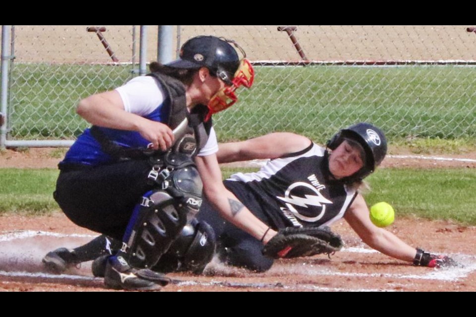 White Lightning player Chelsea Wahl safely slid into home plate to score a run against Odessa, helping her team to a 10-4 win to open the season