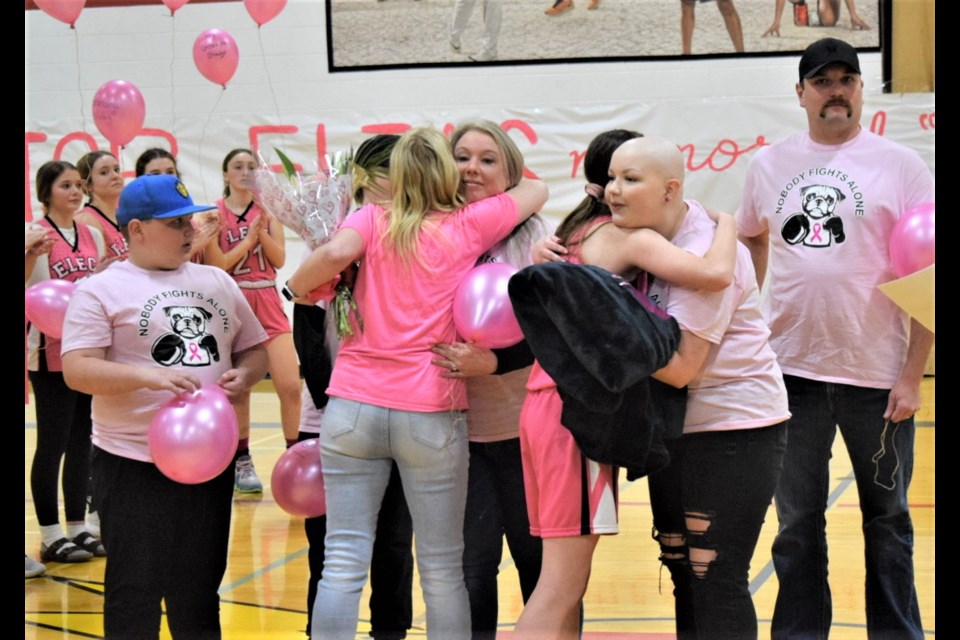 The Lesy family received hugs from  the ECS senior girls' basketball team during the opening ceremonies. 