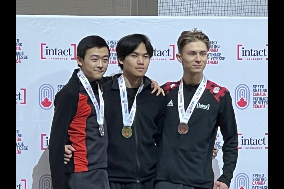 Flag bearer, Luca Veeman, long track speed skater from Saskatoon (far left) poses with teammates from Team Sask.