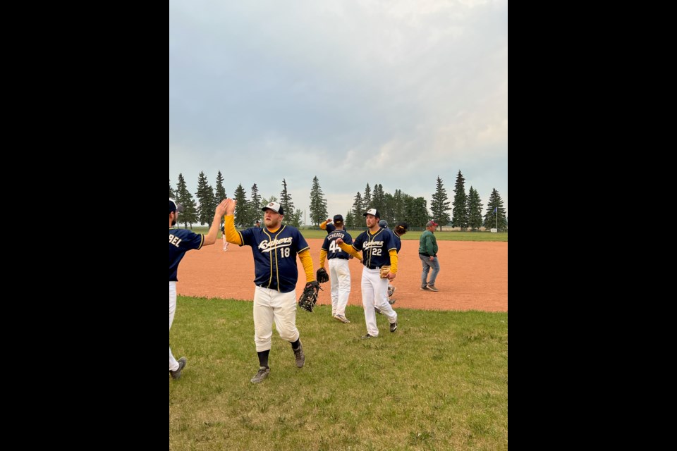 Macklin Sr. Lakers give team high fives after a shut-out victory to take top spot in Battle River Baseball League standings.