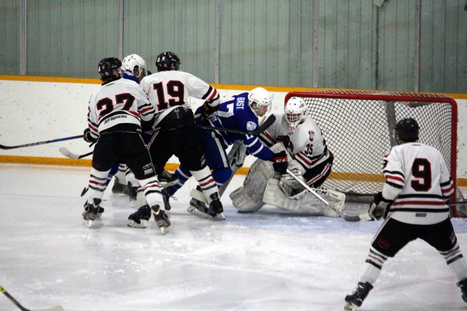 Macklin's Spencer Bast plows through traffic to attempt to shovel the puck past Hafford Hawks goaltender in an earlier season game.
