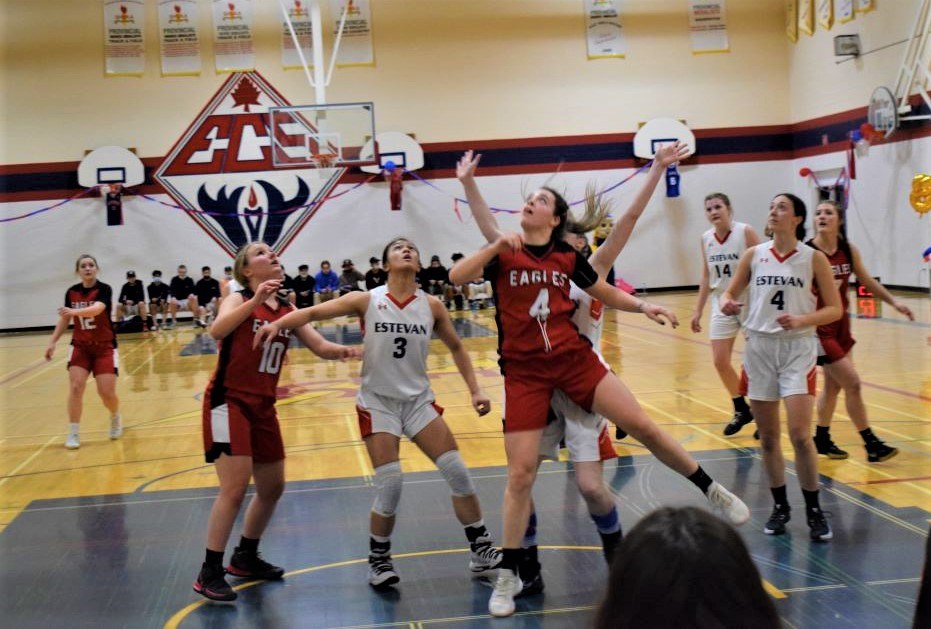 The Estevan Comprehensive School Elecs and Weyburn Comprehensive School Eagles senior girls basketball teams await a rebound in last year's McLeod Series.