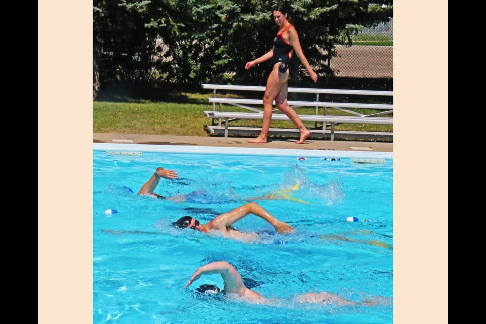 Olympic medalist Chantal van Landeghem walked along the side of the pool watching as Silver Seals swam so she could see their swimming technique.