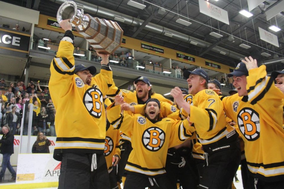 Bruin captain Erik Houk celebrates with his teammates after accepting the SJHL championship trophy. 