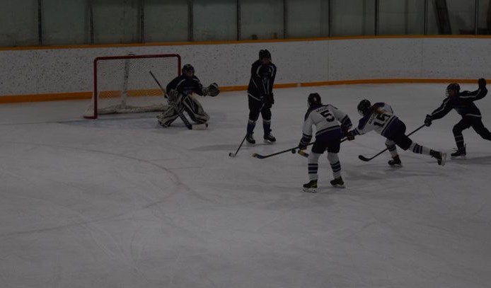 Supported by teammate Marlee Sedor, No. 5, of Yorkton, Jessica Madsen of Theodore (white jerseys) rifled a shot on goal for the Prairie Ice. The shot was stopped, but led to a goal by their line mate Alaina Roebuck of Buchanan in Game 3 in Canora versus the Swift Current Colts.