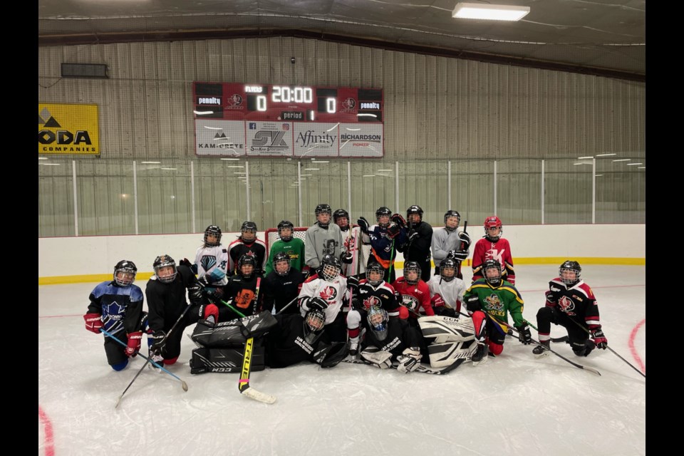 The U11 and U12 teams came together for a photo as they lit up the new scoreboard.