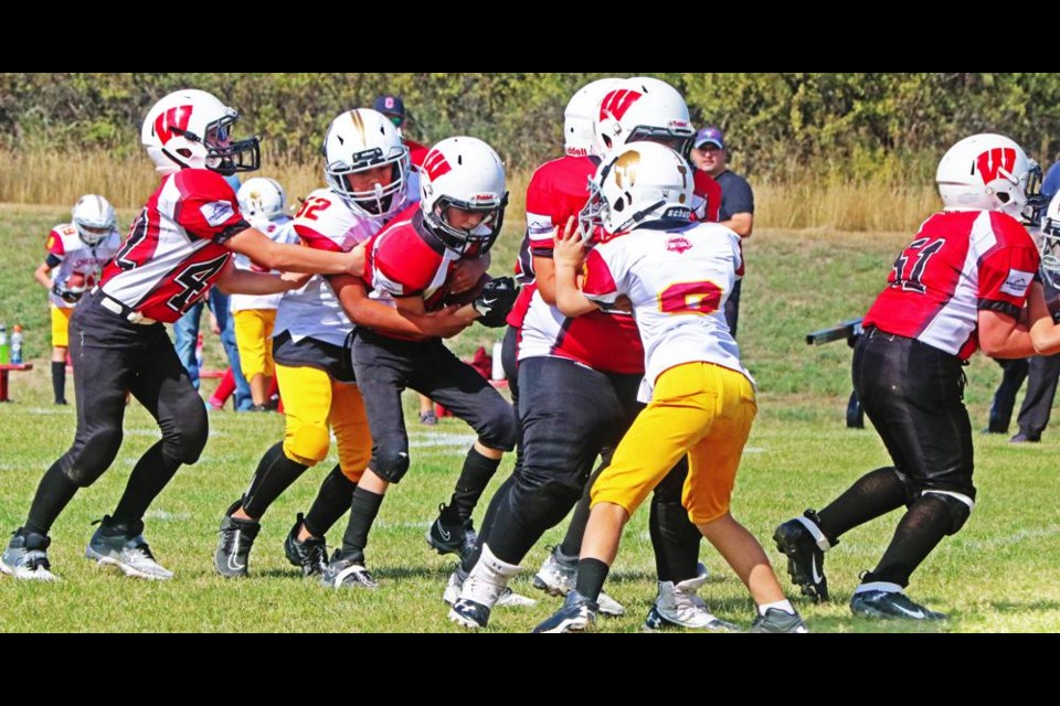A Weyburn Ravens ball carrier tried making some yards on this play vs Moose Jaw on Saturday.