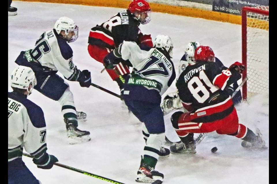 Red Wings players Cade Meiklejohn and Jaxson Ruthven rushed the net in a scoring attempt on Kindersley on Saturday evening.