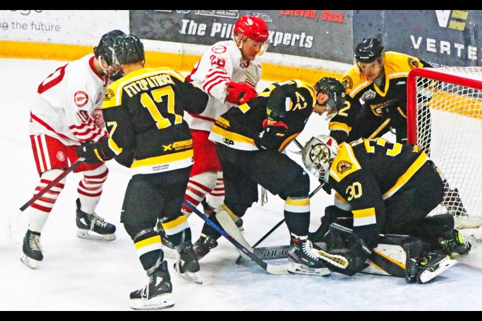 The Weyburn Red WIngs and Estevan Bruins crowd the Estevan net during the teams' first exhibition game on Sunday.