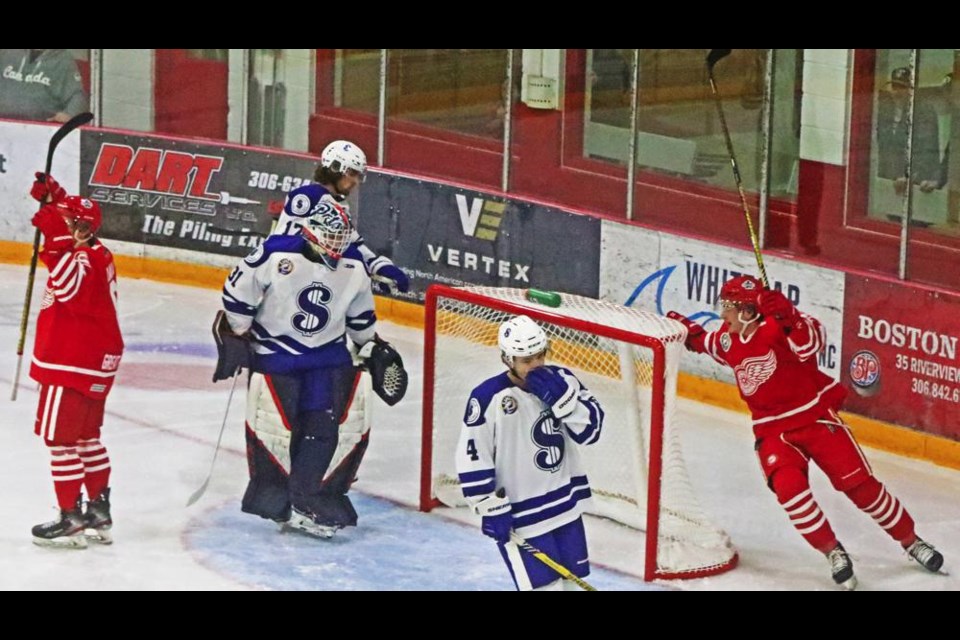 Red Wings players Jakob Kalin and Ty Mason celebrate Kalin's goal to open scoring on Saturday vs Melville; the Wings went on to win 7-5 at home.