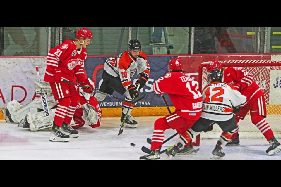 Red Wings players swarmed the front of the net with the goalie out, and kept the puck out of the net in this play on Saturday night.