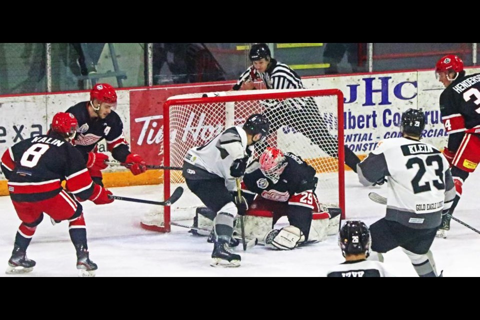 Red Wings player Jakob Kalin, left, watched as goalie Matt Schoephoerster made a save on a Battlefords North Stars player on Friday evening at Crescent Point Place.