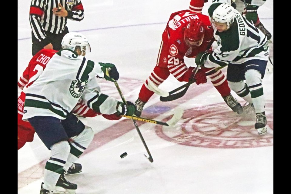 Red Wings Kirk Mullen and Davis Chorney battle for puck control from the opening faceoff on Friday evening at Crescent Point Place