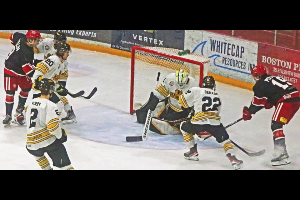 Red Wings forward Simon Pollock, at right, tried stuffing the puck in the side of the net on this play on Saturday vs Nipawin.
