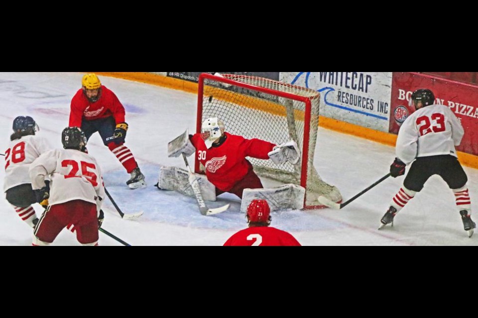 Team Red goaltender Braxton Singleton deflected aside a shot by Team White's Trevor Sanderson, No. 28 at left, as teammate Andrew Low, No. 25, and Blake Betson, No. 23, watched.