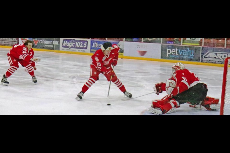 Red Wing Ty Mason went in on goalie Carter Phair while teammate Sebastian Hamming followed to video the shot on his phone