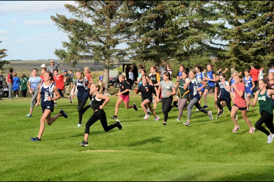 And the race is on!  Peewee girls near the start of their cross-country race at the Unity Golf Course Sept. 15.