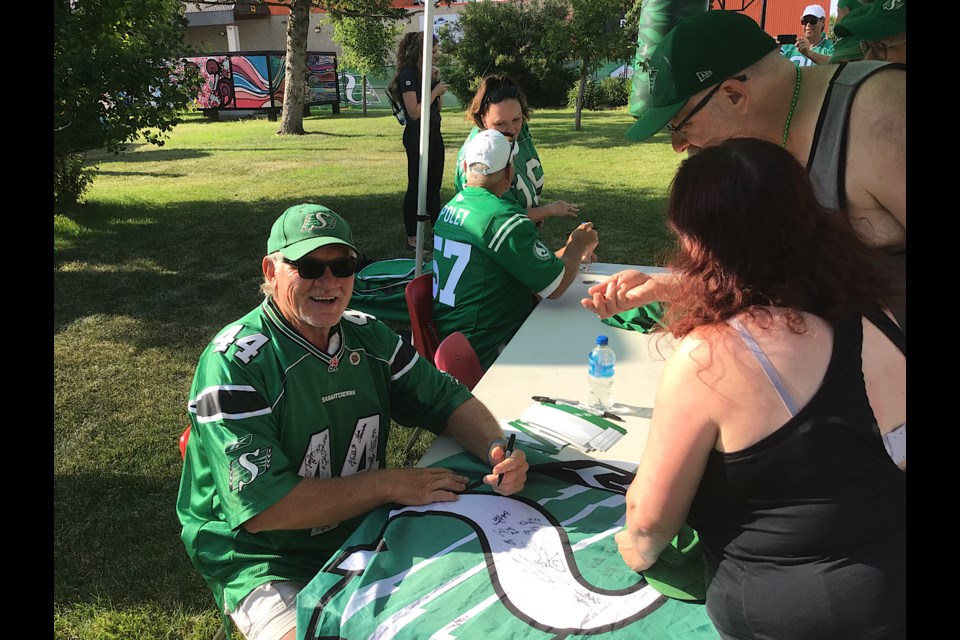 Roughrider legend Roger Aldag seen here signing autographs on Throwback Thursday.