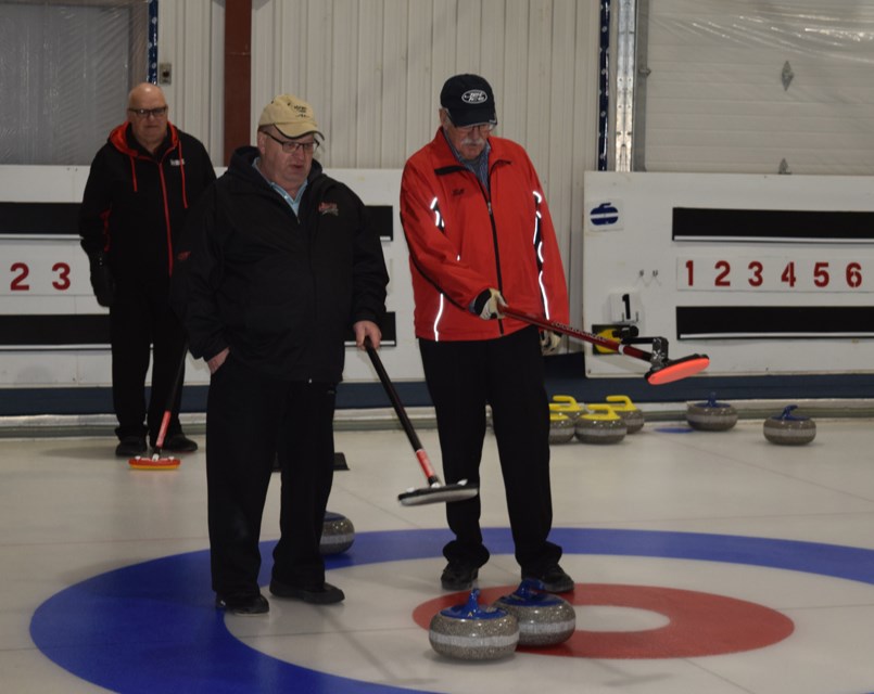 Clarence Homeniuk, left, and Bill Foreman checked out all the possibilities before deciding where to place the broom for Foreman’s next shot at the Canora Senior Bonspiel, held from Jan. 16-19.