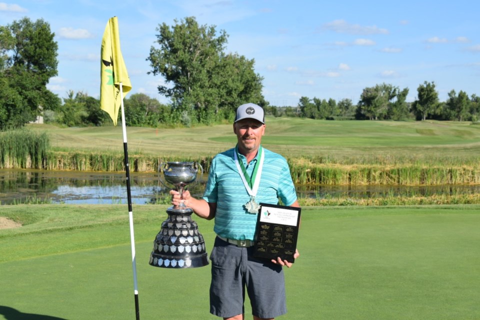 Rick Hallberg with the two championship trophies he won Thursday in Estevan. 