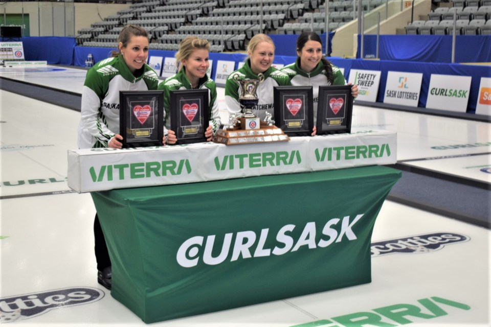 Members of the Robyn Silvernagle rink gather after winning the Viterra Scotties Tournament of Hearts. 