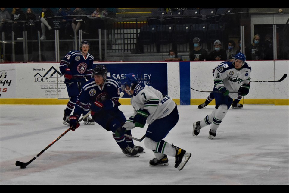 Melville Millionaires forward Rylan Bruns, left, tries to keep the puck away from Melfort Mustangs defenceman Lucas Ochitwa in their game in the Saskatchewan Junior Hockey League on Tuesday at the Legends Centre in Warman.