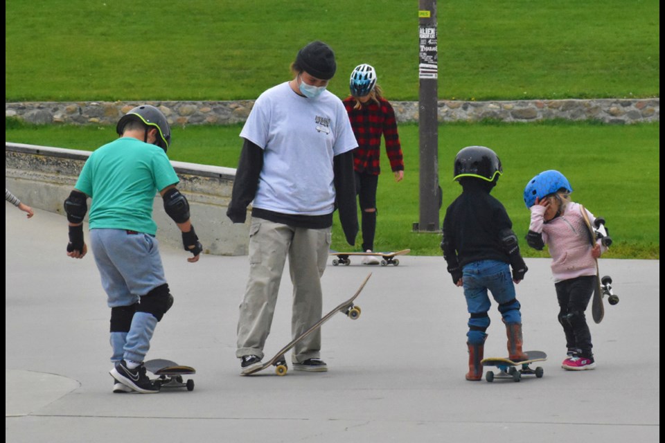 A member of Right to Skate teaches some kids the basics of skateboarding in last Saturday's Fall Freestyle Fall Lions Skate Park in Victoria Park.