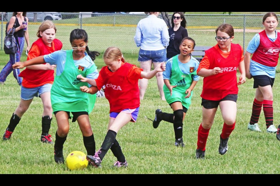 Opposing players battled for possession of the ball, during Weyburn Soccer's family fun day on Saturday