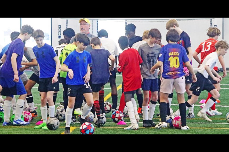 A group of U15 boys had to bring their ball in to the centre and back out again without interfering with anyone else, in this drill at the Forge team tryouts on Saturday.