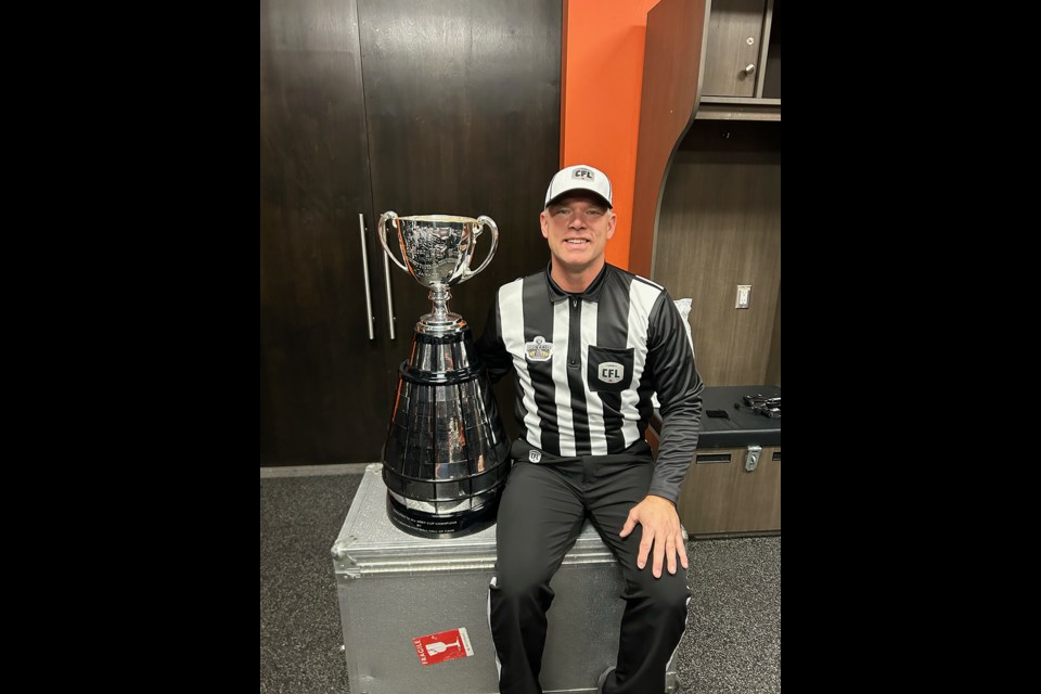Saskatoon's Tim Kroeker sits with the Grey Cup following his role as head referee for the 110th Canadian Football League championship game, Nov. 19.