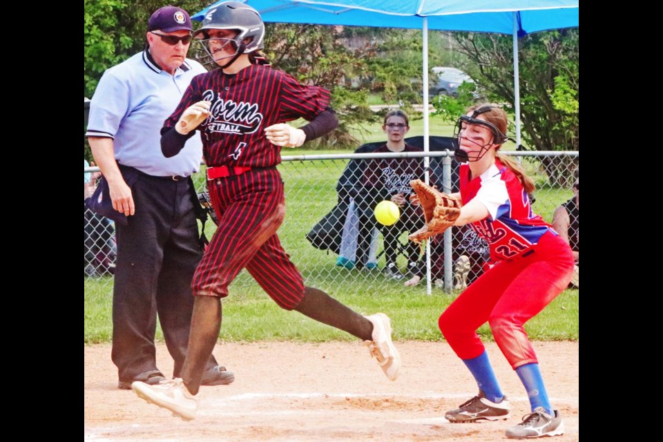 Pitcher Ireland Koski waited for the throw as the Storm player crossed the plate for the run, in this play in the first of a doubleheader.