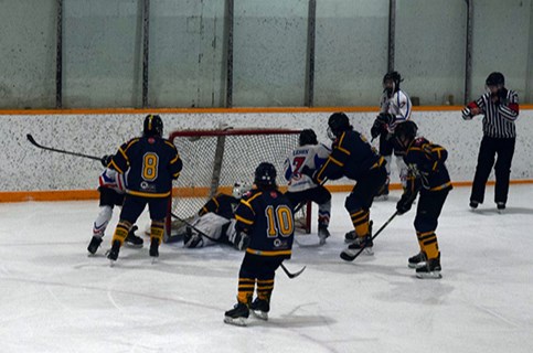 Somehow, Shiloh Leson of the U13 Canora Cobras (No. 7, white jersey) found a way to jam the puck into the net during this wild scramble against Fort Knox in Game 2 on March 25 in Canora.