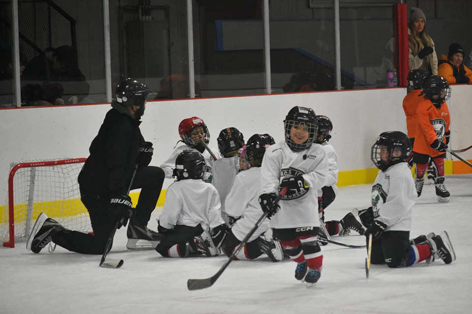 U7 Canora Cobras Coach Parker Rice organized a game plan for his team.
