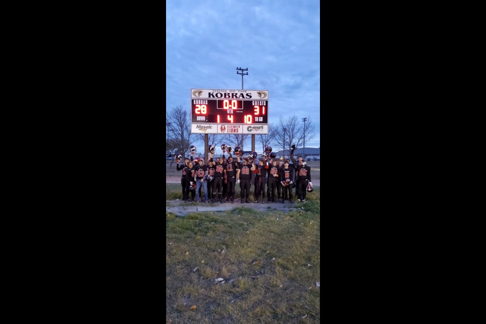 The UCHS Warriors proudly stand with the scoreboard after a dramatic last second win in Kindersley Oct. 23.