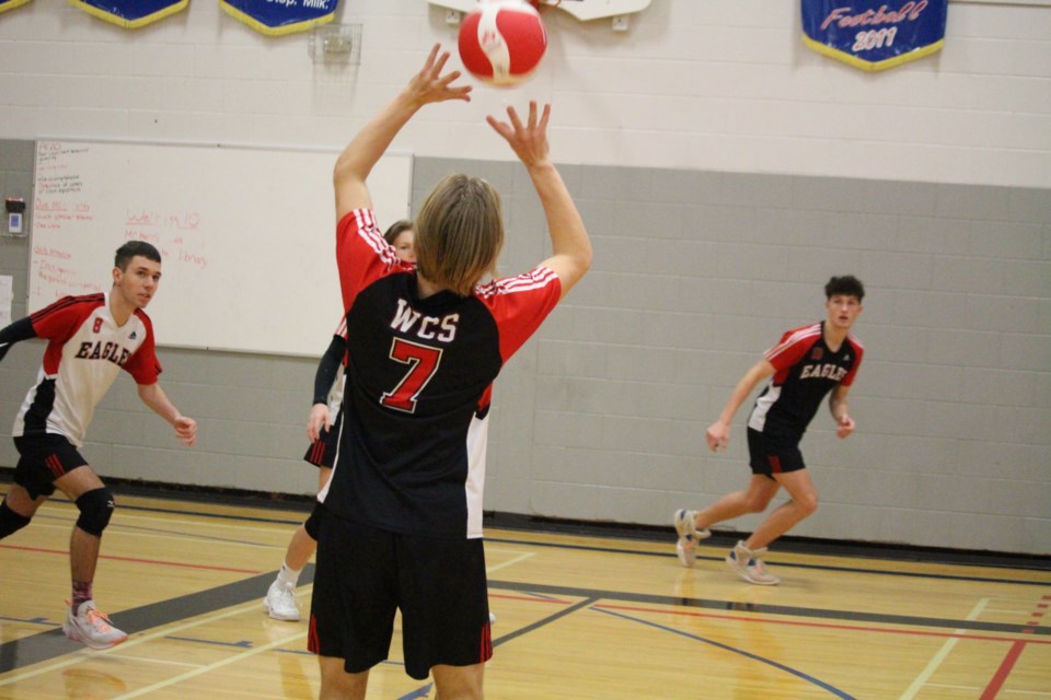 Mitchell Cherpin (#7) sets up the ball, as teammates move into position during the first game.