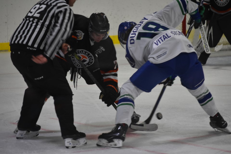 Clay Sleeva of the Terriers and Ryan Dugay had an intense on the faceoff, with linesman Donovan Florek dropping the puck.