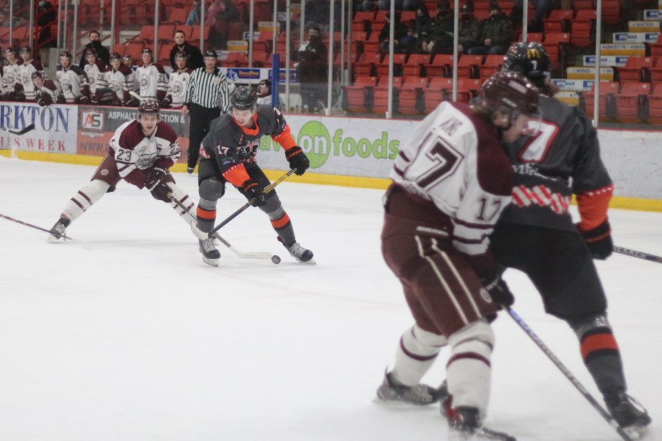 Terriers' forward, Greg Nelson battling for the puck.