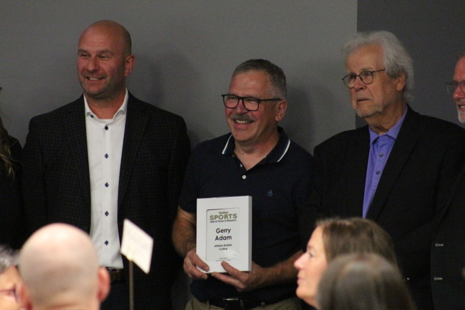 Gerry Adam, center, inducted into both the athlete and builder category for contributions and achievements in the sport of curling.