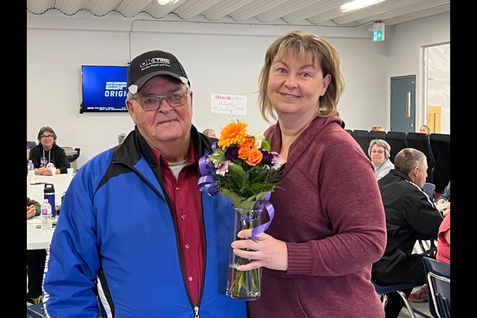 Dwain Davis presents Shelley Harkness with a gift for 10 years of dedication to the Arcola youth curling program. 