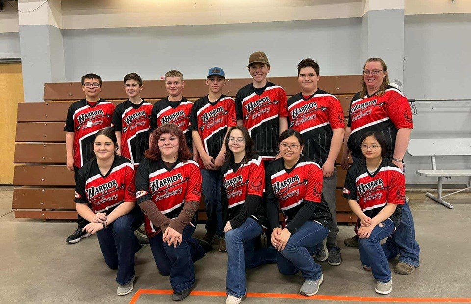 The 2025 UCHS Warrior Archery team included 12 students. Back: Lane Thompson, Xander Wells, Tate Pool, Dylan Pool, Sebastian Lauinger, Hunter Ireland, coach Brenda Pool. Front: Aliya Keller, Holly Lauinger, Jenay Bishop, Elisha Avena, Elise Avena. Missing: Oaken Jedlicka