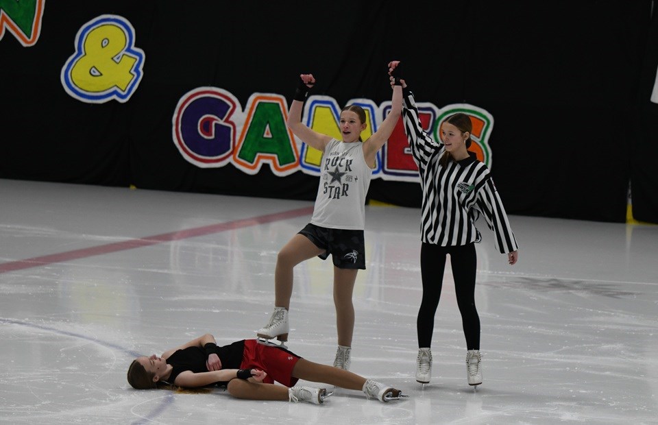 Referee Kailey Bertoia crowns Brynn Delhommeau the winner over Annie Pitura at the conclusion of a fun boxing-themed choreography skated to Eye of the Tiger.