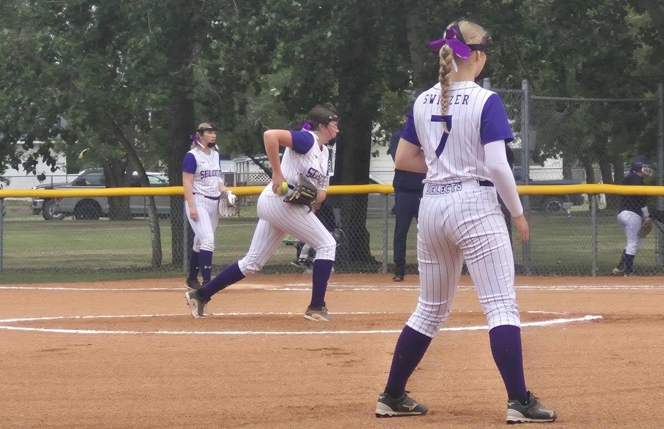 Beauty in bows — the Lacombe Selects team stood out in their bright white uniforms and purple hair bows against the lush green grass and brick red shale.