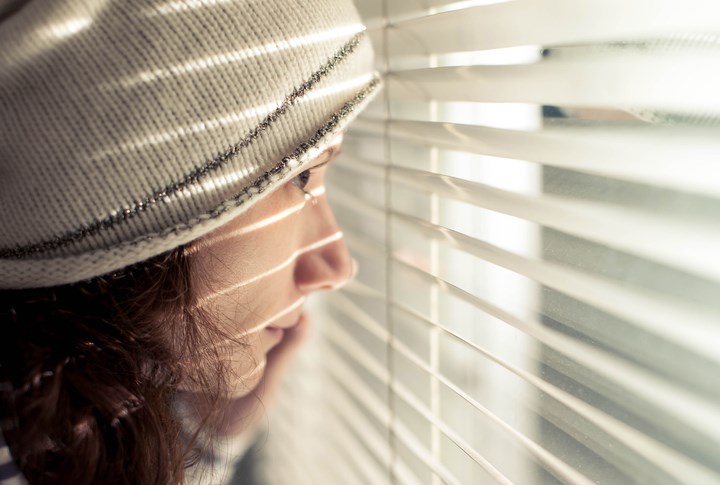 Girl looking through window