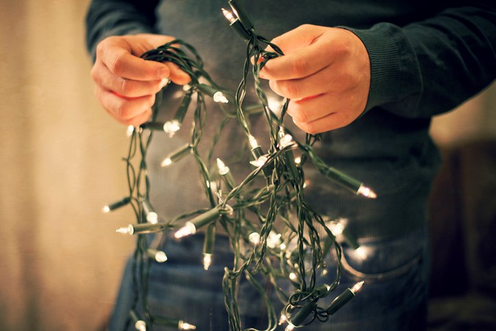 Man holding fairy Christmas lights