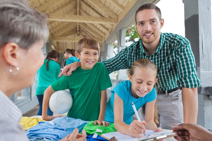 Parent signing children up to play soccer or team sport