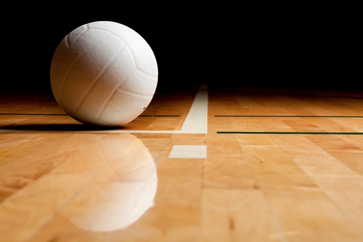 volleyball and reflection on a wooden floor