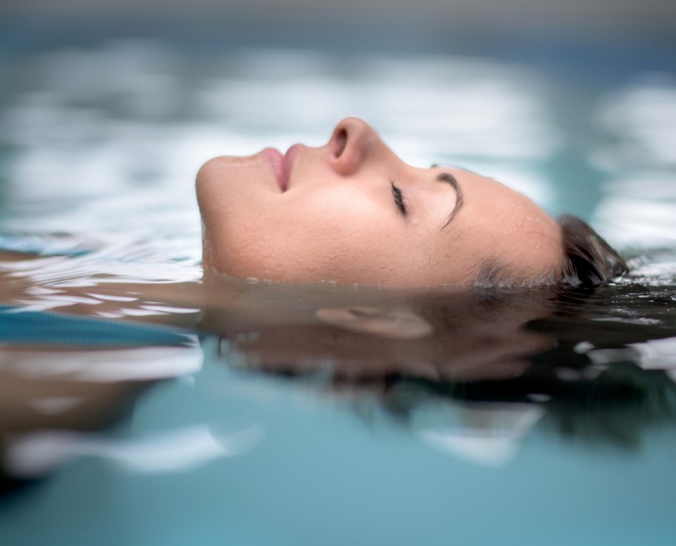 woman-in-pool-swimming-stock